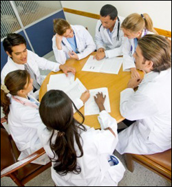 Group of nurses or doctors sitting at a table in a meeting  