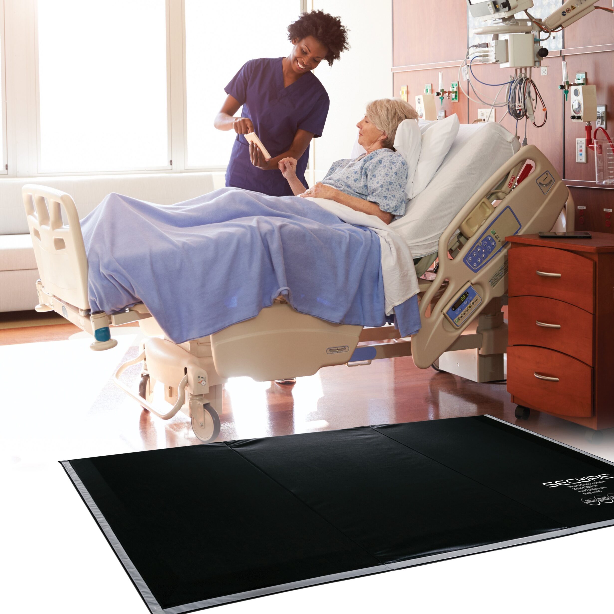 Hospital Nurse with Digital Tablet Talks To Senior Patient Secure